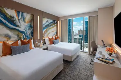 a hotel room with two beds and a large window at Courtyard New York Manhattan/Midtown West in New York