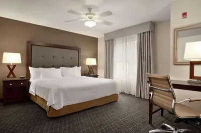 a hotel room with a bed and a desk at Homewood Suites by Hilton Dover - Rockaway in Dover