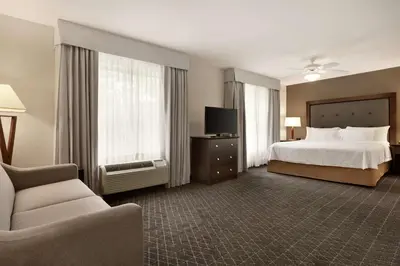 a hotel room with a bed and a tv at Homewood Suites by Hilton Dover - Rockaway in Dover