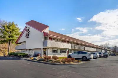 a building with cars parked in a parking lot at Red Roof Inn Danville, PA in Danville