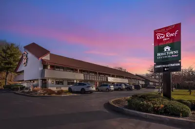 a building with cars parked in a parking lot at Red Roof Inn Danville, PA in Danville