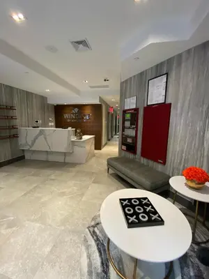 a lobby with two tables and a soda machine at Wingate by Wyndham New York Midtown South/5th Ave in New York