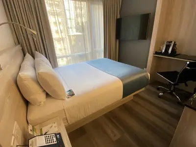 a hotel room with a bed and a window at Wingate by Wyndham New York Midtown South/5th Ave in New York