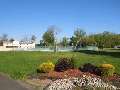 a park with a tennis court in the background at Value Inn East Stroudsburg in Marshalls Creek