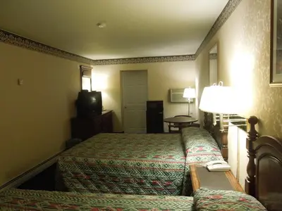 a hotel room with two beds and a television at Value Inn East Stroudsburg in Marshalls Creek