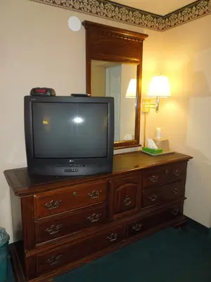 a television sitting on top of a dresser in a room at Value Inn East Stroudsburg in Marshalls Creek