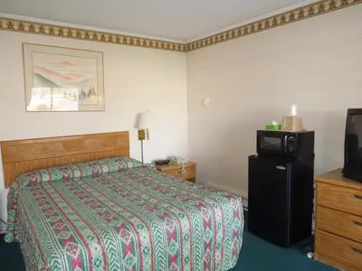 a hotel room with a bed and a tv at Value Inn East Stroudsburg in Marshalls Creek