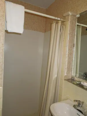 a bathroom with a shower and a sink at Value Inn East Stroudsburg in Marshalls Creek