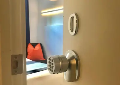 a door with a door knob and a red chair at Modern GuestHouse Ironbound Newark with KITCHEN-FastTrainToNYC-OneStopToAirport in Newark