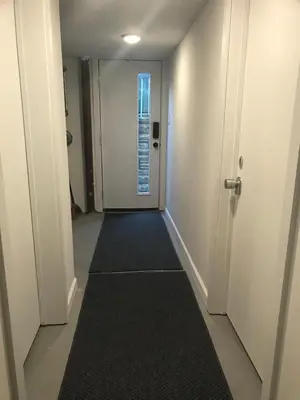 an empty hallway with a door and a carpet at Modern GuestHouse Ironbound Newark with KITCHEN-FastTrainToNYC-OneStopToAirport in Newark