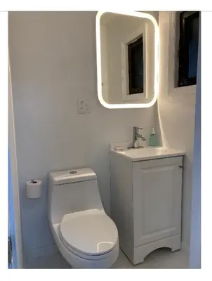 a bathroom with a toilet and a sink and a mirror at Modern GuestHouse Ironbound Newark with KITCHEN-FastTrainToNYC-OneStopToAirport in Newark