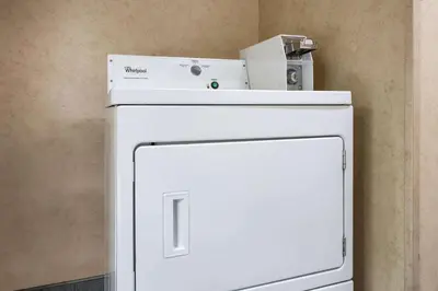 a white refrigerator with a box on top of it at Days Inn by Wyndham Runnemede Philadelphia Area in Runnemede