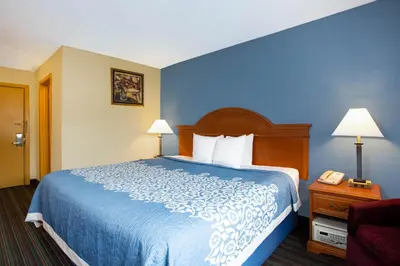 a hotel room with a bed and a telephone at Days Inn by Wyndham Runnemede Philadelphia Area in Runnemede