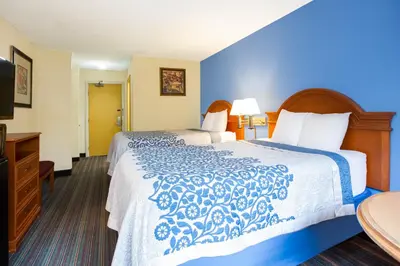 a hotel room with a bed and a television at Days Inn by Wyndham Runnemede Philadelphia Area in Runnemede
