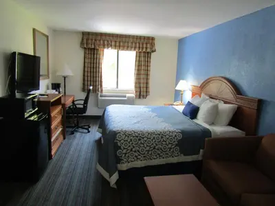 a hotel room with a bed and a television at Days Inn by Wyndham Runnemede Philadelphia Area in Runnemede