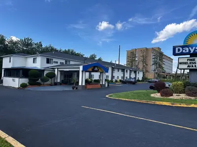a days inn with a sign in a parking lot at Days Inn by Wyndham Runnemede Philadelphia Area in Runnemede