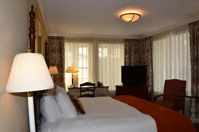 a hotel room with a bed and a television at The Wall Street Inn in New York