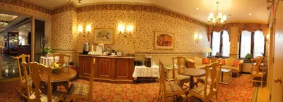 a living room with a table and chairs and a couch at The Wall Street Inn in New York
