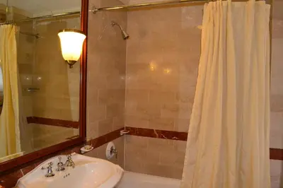 a bathroom with a sink and a shower at The Wall Street Inn in New York