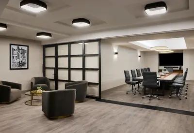an office with a conference room with a table and chairs at Gansevoort Meatpacking in New York