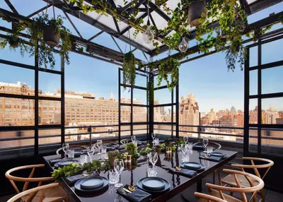 a table in a room with a view of the city at Gansevoort Meatpacking in New York