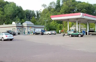 a gas station with cars parked in a parking lot at Motel 6-Bloomsburg, PA in Bloomsburg