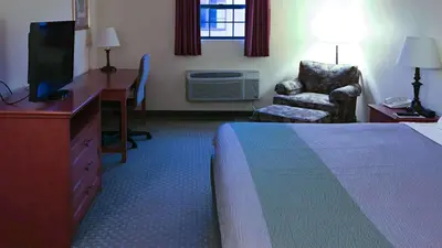 a hotel room with a bed and a desk and a chair at Motel 6-Bloomsburg, PA in Bloomsburg