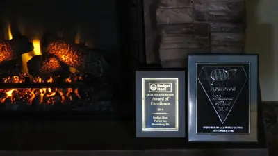 two framed signs in front of a fireplace at Motel 6-Bloomsburg, PA in Bloomsburg