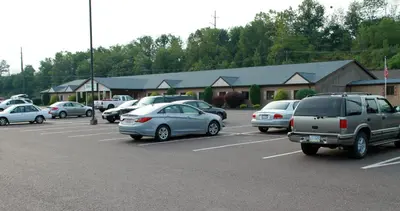 a parking lot with many cars parked in it at Motel 6-Bloomsburg, PA in Bloomsburg