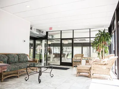 a living room with a couch and chairs at The Manor on Front in Harrisburg