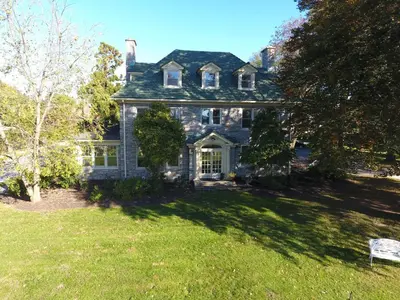 a large house with a grass yard in front of it at The Manor on Front in Harrisburg