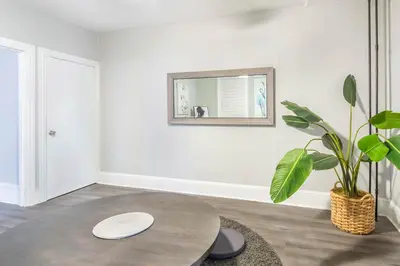 a living room with a table and a plant at Philly Coed Dorm!! 15 Min Train to Center City!! in Philadelphia