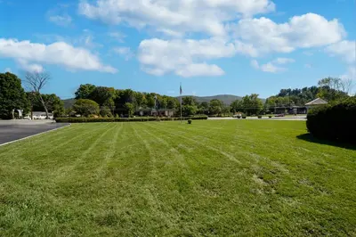 a large field of green grass on a street at Americas Best Value Inn at Central Valley-Woodbury in Central Valley