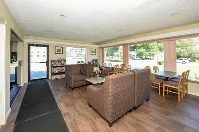 a living room with a couch and a table and chairs at Americas Best Value Inn at Central Valley-Woodbury in Central Valley