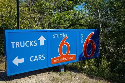 a blue sign that says trucks and cars at Motel 6-East Brunswick, NJ in East Brunswick