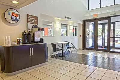 a restaurant with a counter and a table and chairs at Motel 6-East Brunswick, NJ in East Brunswick