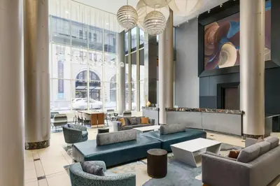 a lobby with couches and chairs and a fireplace at Fairfield Inn & Suites by Marriott New York Midtown Manhattan/Penn Station in New York