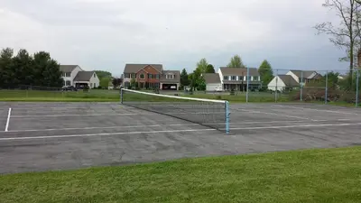 a tennis court with a net in the middle at Americas Best Value Inn - Palmyra/Hershey in Palmyra