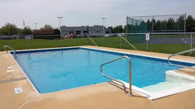 a large swimming pool in a tennis court at Americas Best Value Inn - Palmyra/Hershey in Palmyra
