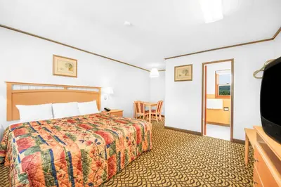 a hotel room with a bed and a flat screen tv at Knights Inn Pine Grove in Pine Grove
