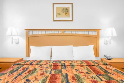 a hotel room with a bed and two night stands at Knights Inn Pine Grove in Pine Grove