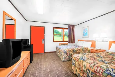 a hotel room with two beds and a flat screen tv at Knights Inn Pine Grove in Pine Grove