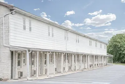 a large white building with a lot of windows at Knights Inn Pine Grove in Pine Grove