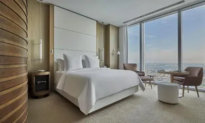 a bedroom with a large white bed and large windows at Four Seasons Hotel Philadelphia at Comcast Center in Philadelphia