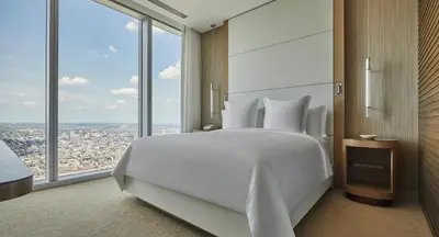 a bedroom with a large white bed and large windows at Four Seasons Hotel Philadelphia at Comcast Center in Philadelphia