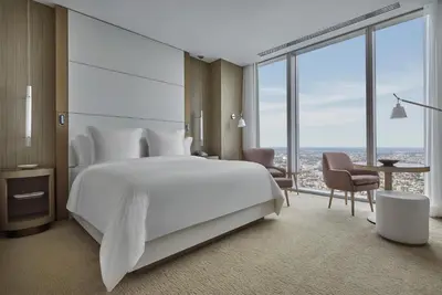 a bedroom with a large white bed and large windows at Four Seasons Hotel Philadelphia at Comcast Center in Philadelphia