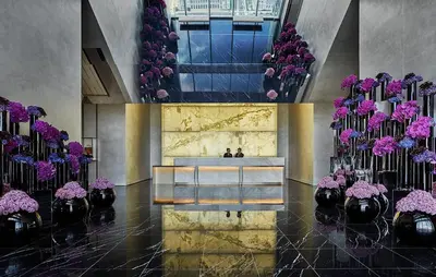 a lobby with vases of purple flowers and a bench at Four Seasons Hotel Philadelphia at Comcast Center in Philadelphia
