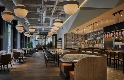 a restaurant with tables and chairs and lights at Four Seasons Hotel Philadelphia at Comcast Center in Philadelphia