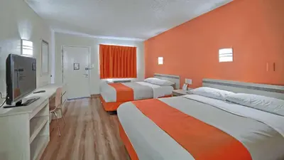 a hotel room with two beds and a flat screen tv at Motel 6-Maple Shade Township, NJ - Philadelphia - Mt Laurel in Maple Shade