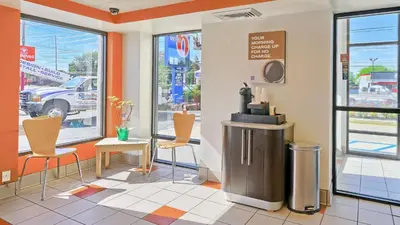 a fast food restaurant with chairs and a table and windows at Motel 6-Maple Shade Township, NJ - Philadelphia - Mt Laurel in Maple Shade